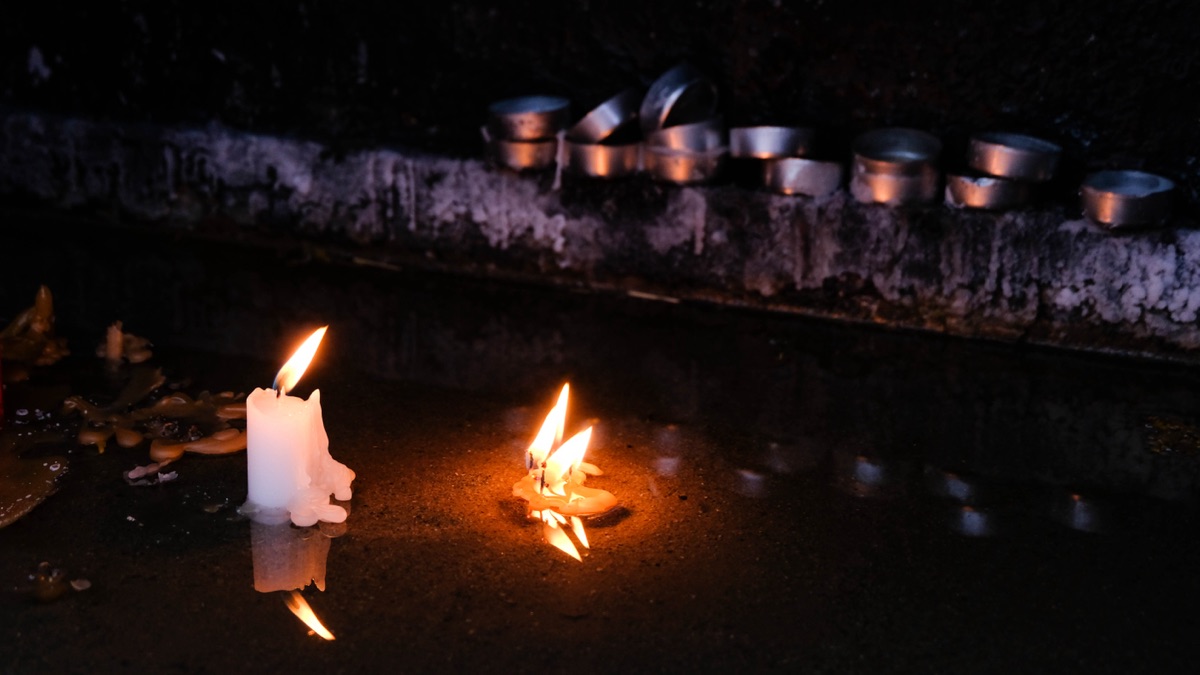 Lit candles in the dark for All Saints' Day